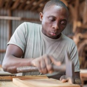 Artisan menuisier en train de réaliser du mobilier en bois massif de Guyane pour la marque DISSI.