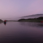 Marais de Kaw en Guyane au leve du soleil. En canoe et en kayaks. Lune en arriere plan.