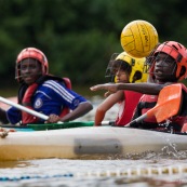 Kayak polo en Guyane, lac saccharin. Jeune jouant avec un ballon en kayak en exterieur. Pres du sentier du rorota a Remire Montjoly.